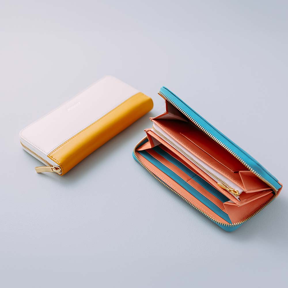 シンプルラウンド長財布（バイカラー） - 全部で5か所のカラーカスタマイズが可能です。洗練されたバイカラーデザインでシンプルながらもおしゃれさを演出することができます。ステッチも革色毎に変え、革職人による繊細なハンドメイド仕上げ。プレゼントにふさわしい細部へのこだわりを徹底しています。